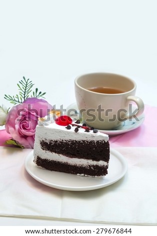 Black Forest Cake and  cherry on top, with cup of tea