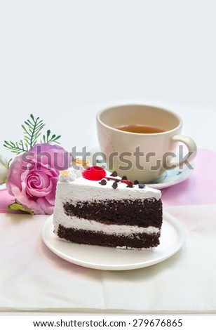 Black Forest Cake and  cherry on top, with cup of tea