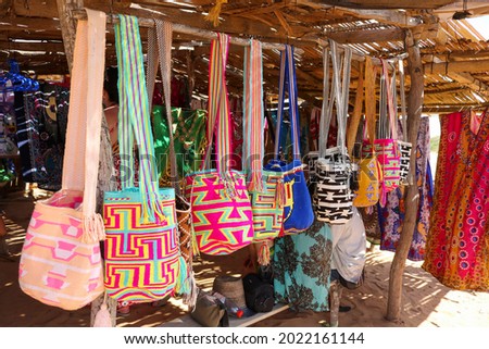 A closeup of colorful thread bags made by indigenous Wayuu people in Cabo de la Vela in La Guajira, Colombia. Crafts by local people in Colombian desert. Photo stock © 
