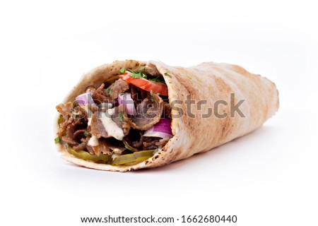 Shawarma sandwich fresh roll of, Grilled Meat and salad tortilla wrap with white sauce isolated on white background. Image