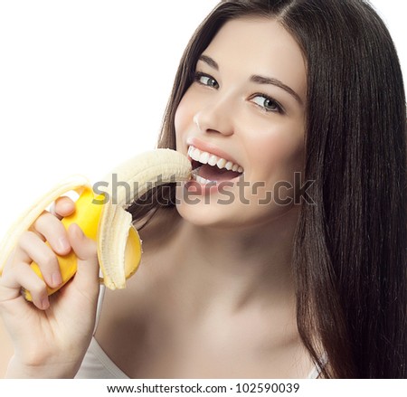 portrait of attractive  caucasian smiling woman isolated on white studio shot eating banana