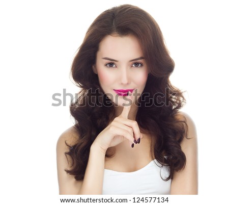 portrait of attractive  caucasian  woman brunette isolated on white studio shot finger secret