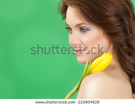 closeup portrait of attractive  caucasian  woman brunette  studio shot lips  face hair head and shoulders makeup skin tulip flower spring
