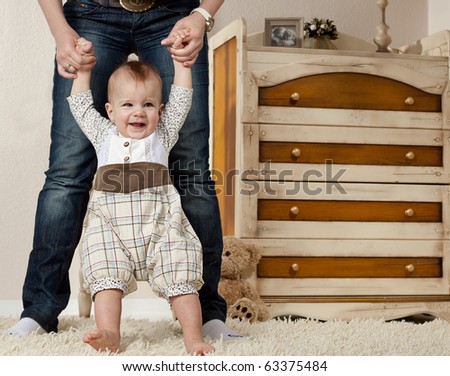 little child baby smiling making first steps