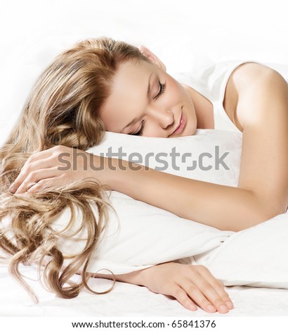 attractive  woman slipping in bed on white background