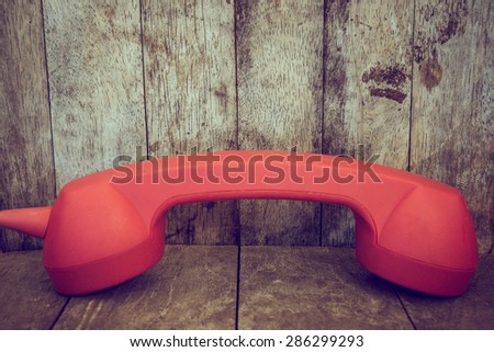 Red phone on wood
