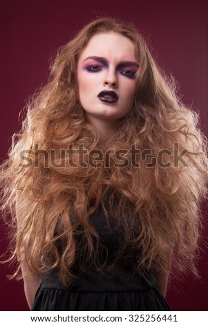 Closeup beautiful portrait of a young cute girl over white background. Woman with perfect bright makeup. Pink shadows and dark lips. Pretty blonde. With long hair. Light effect.