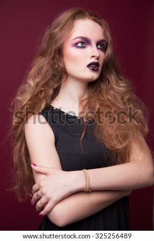 Closeup beautiful portrait of a young cute girl over white background. Woman with perfect bright makeup. Pink shadows and dark lips. Pretty blonde. With long hair.
