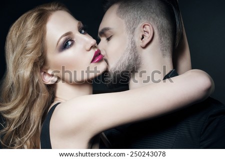 Passionate couple. Beautiful young man and blond woman closeup. Woman hugging man. Love. Flirt. Kiss. Lovers. Valentine couple