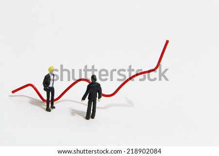 Miniature people talking about the red trend line