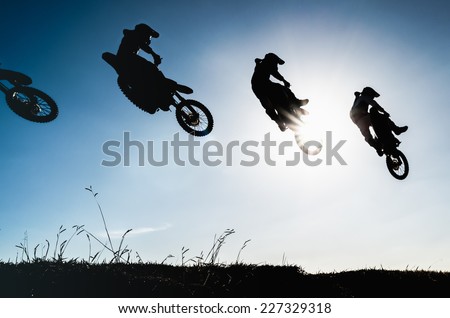 Sequence of a motocross jump in silhouette with blue sky and sun