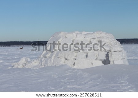 Snow construction of igloo standing on a snow-covered glade in the winter