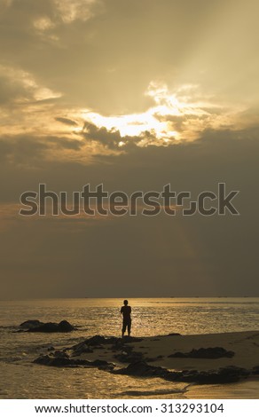 Landscape of sea and cloudy sky which has sun beam shine on sea water and beach in morning ; southern of Thailand