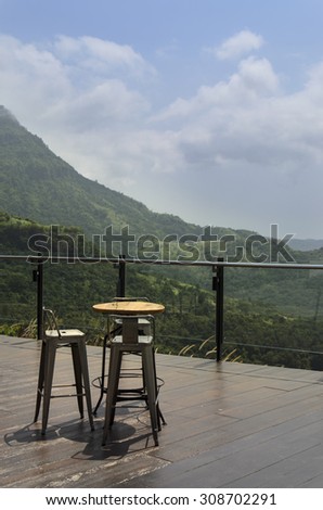 Magnificent outdoor terrace with chairs on sunny terrace with bay view and decoration in contemporary home. Mountain View.