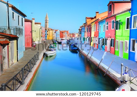 Burano island colorful scenery with bright colorful houses along the canal embankment (Venice, Italy)