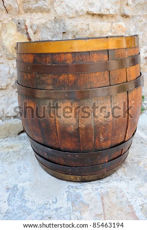 Wine wooden barrel near the old wall