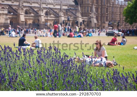 Palace of Westminster, London - 29 June,2013 : In summer, it\'s great time to enjoy sunny morning with friends and family, lying or sitting on the grass with beautiful environment.