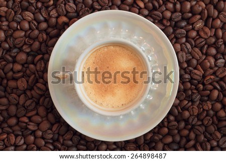 cup of organic coffee on coffee beans