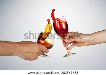 celebrate the holiday background - two hand with alcohol clinking - wonderful splashes