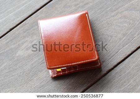 leather wallet brown leather on a wood background