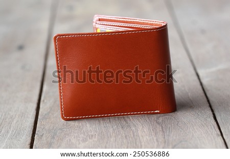 leather wallet brown leather on a wood background