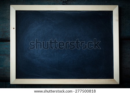 empty Blank chalkboard in wooden frame isolated on wooden background