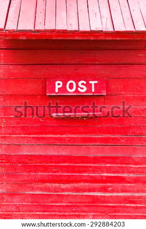 painted Post box color red old wooden wall. red wood background