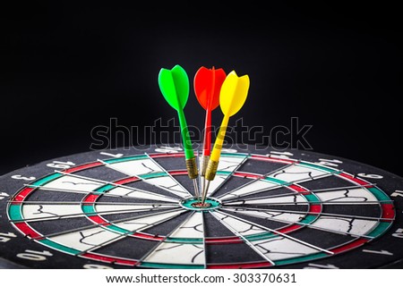 Dart board is the target and goal. Success hitting target aim goal achievement. financial concept with goal money.