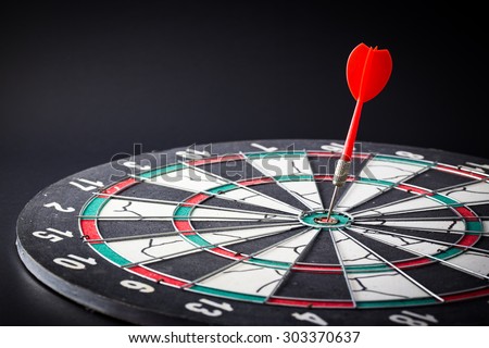 Dart board is the target and goal. Success hitting target aim goal achievement. financial concept with goal money.