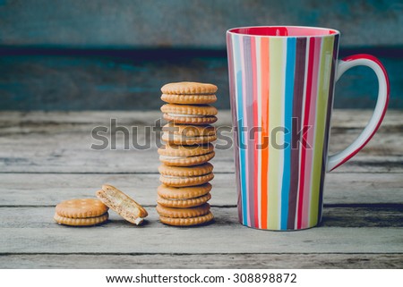 vintage soft tone with cookies bread and colorful mug.