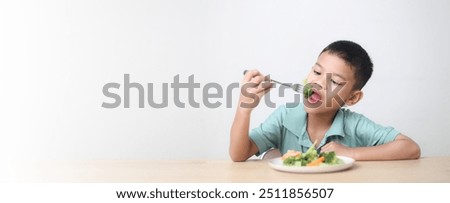 Similar – Image, Stock Photo Child eating fresh carrot