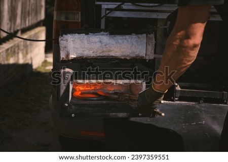 Similar – Image, Stock Photo Blacksmith taking horseshoe from furnace