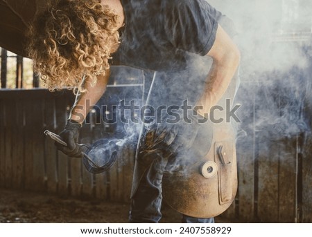 Similar – Image, Stock Photo Blacksmith taking horseshoe from furnace