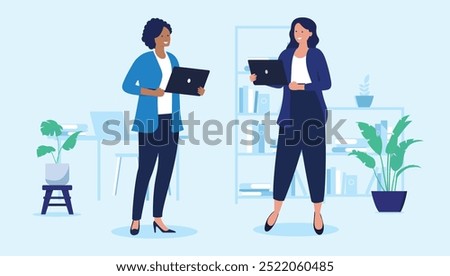 Two women with laptops - Female vector characters standing holding computers in office work setting, smiling and talking together. Flat design illustration with light blue background