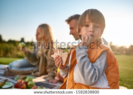 Image, Stock Photo Child eats sandwich outdoor