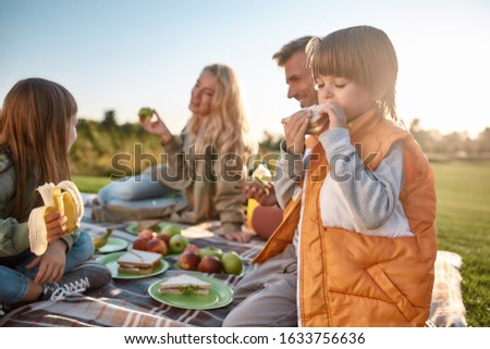 Similar – Image, Stock Photo Child eats sandwich outdoor