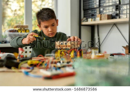 Similar – Image, Stock Photo Boy child using screwdriver at home