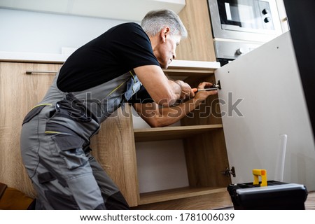 Similar – Image, Stock Photo Aged repairman in professional workshop with tools