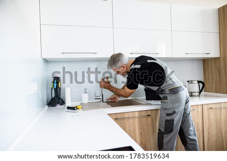 Similar – Image, Stock Photo Repairman fixing old broken motorcycle in workshop