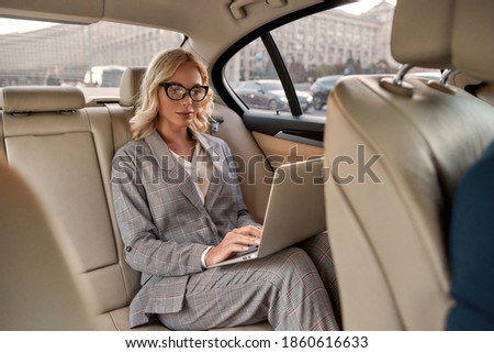 Similar – Image, Stock Photo Stylish traveling woman with backpack resting near sea