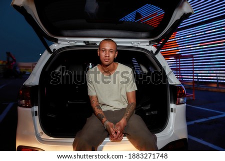 Similar – Image, Stock Photo Serious young stylish guy standing near shabby wall on street