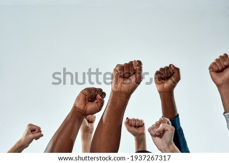 Similar – Image, Stock Photo black fist in the air as a sign of power