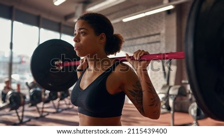 Similar – Image, Stock Photo Serious black sportswoman sitting on stone border in city