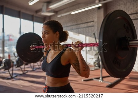 Similar – Image, Stock Photo Serious black sportswoman sitting on stone border in city