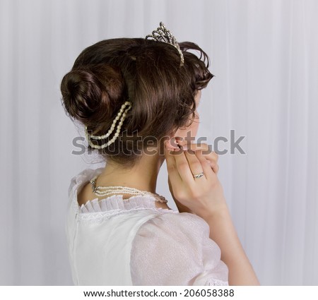 The lady with the hair straightens earring, style Empire