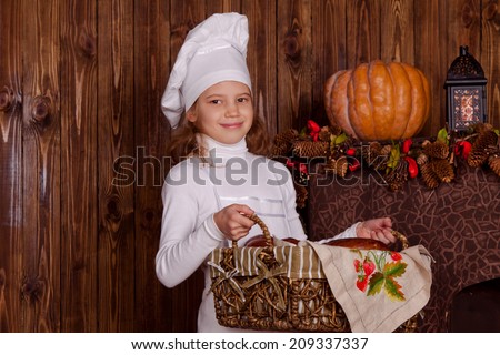 Portrait of a young chef with a basket of pastries