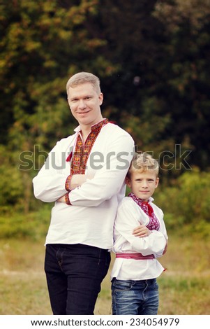 Dad and son in the Ukrainian national clothes. Ukrainian tradition, national character. Ukraine, Kiev, a museum open-air Pirogovo