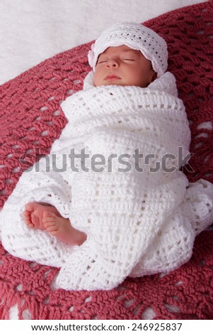 Sleeping newborn baby girl in hat with flowers. Tenderness, health, new life