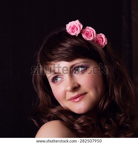 Portrait of a young attractive woman with flowers in her hair. Beauty, health, care