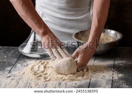 Similar – Image, Stock Photo Cook kneading dough with hand on table